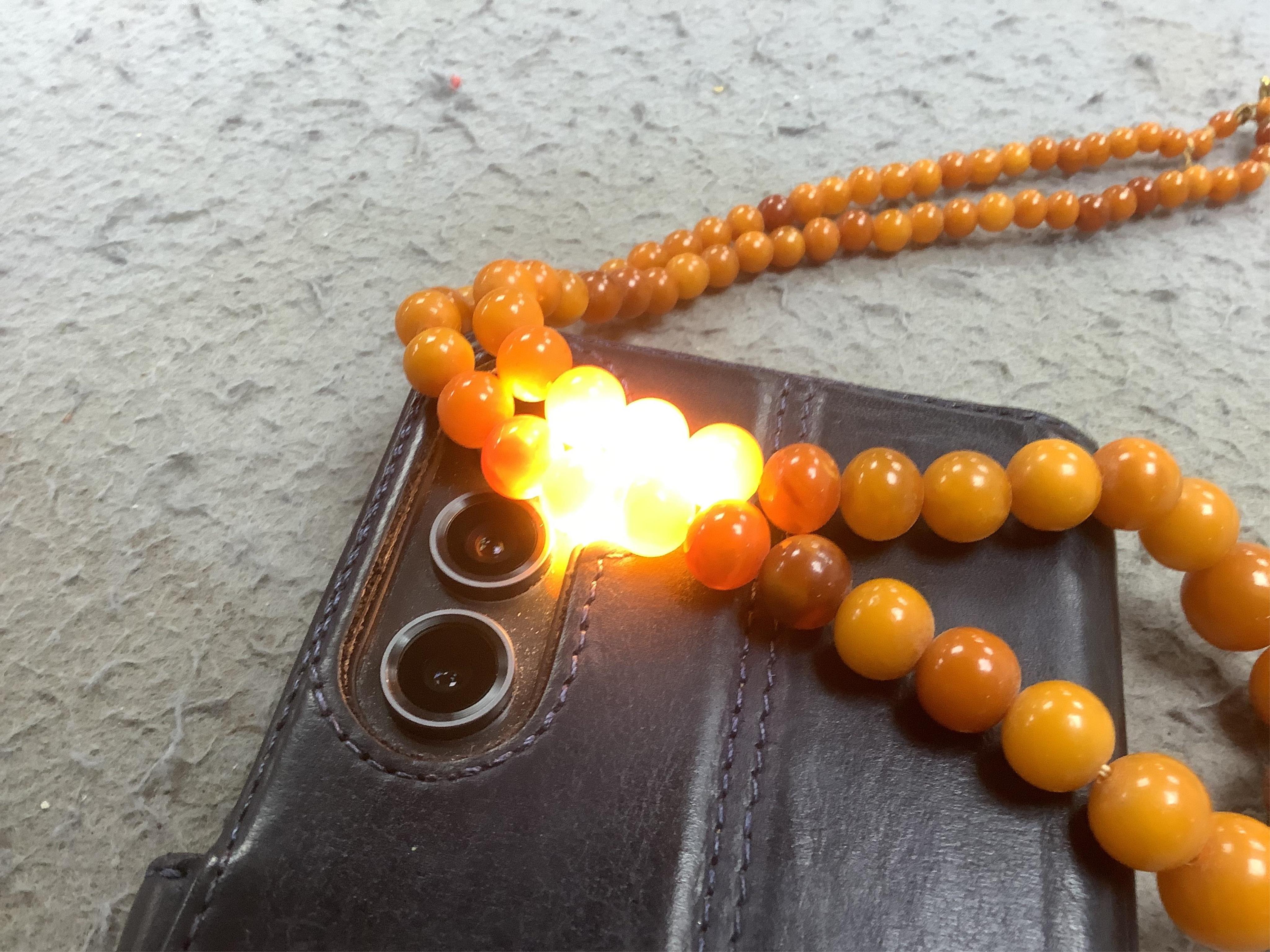 An amber bead necklace, composed of graduated amber beads measuring approximately 15.7-3.6mm, length 58cm, gross weight 23 grams. Condition: overall good, some minor crazing, some minor wear, commensurate with age